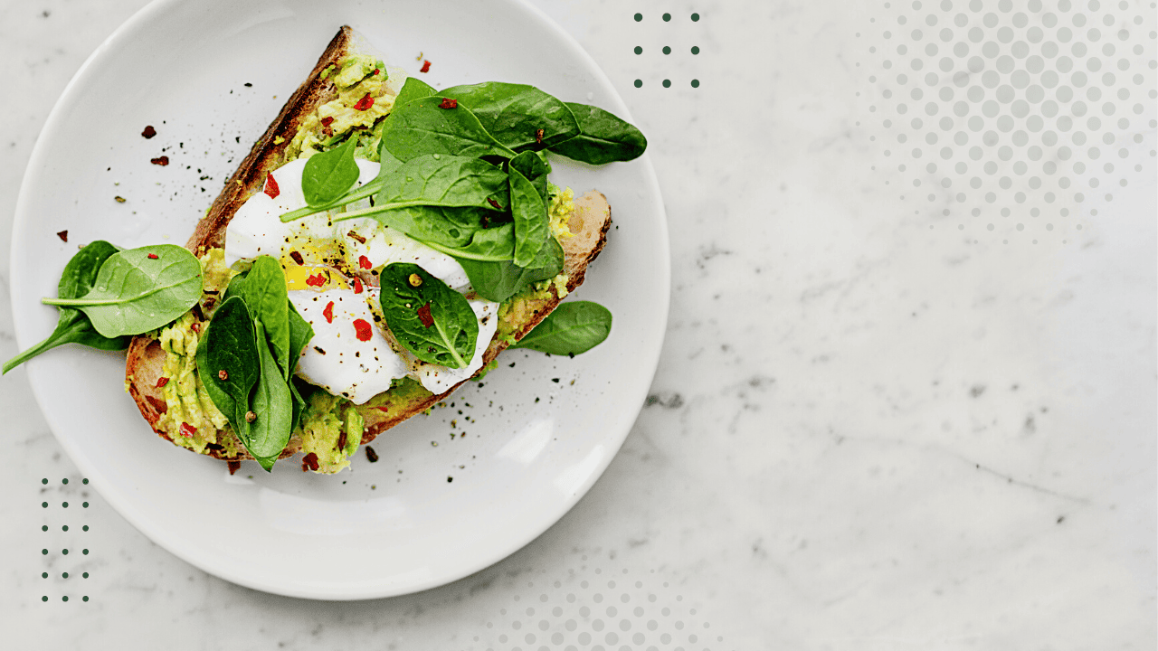 Bright avocado toast topped with fresh spinach and poached egg for a nutritious meal.